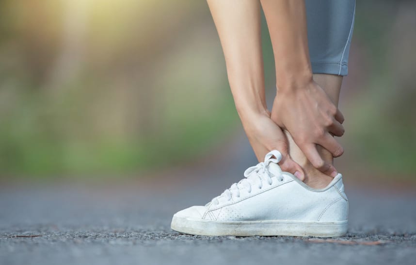 Woman holding ankle