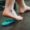 Person placing their foot on an orthotic insert