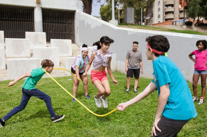 Kids enjoying jump rope outside at summer camp 2023