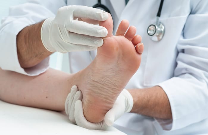 Specialist assessing a patient's foot health