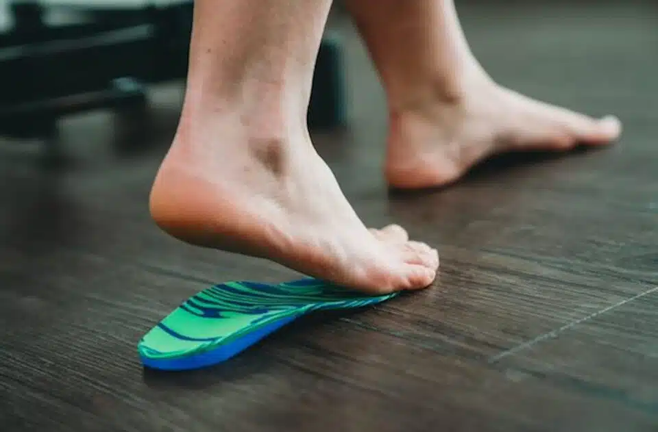 Person placing their foot on an orthotic mold