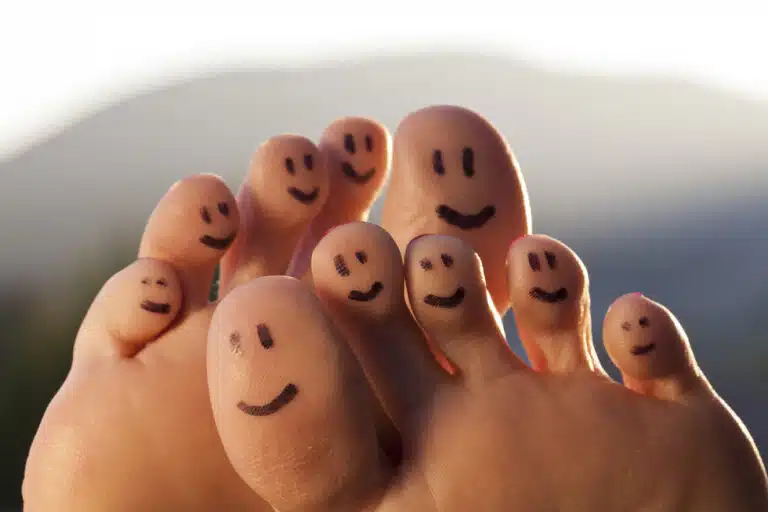 Smiley faces drawn on the bottom of toes