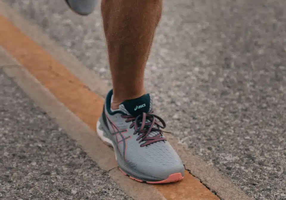 Runner with proper Asics running shoes providing cushioning