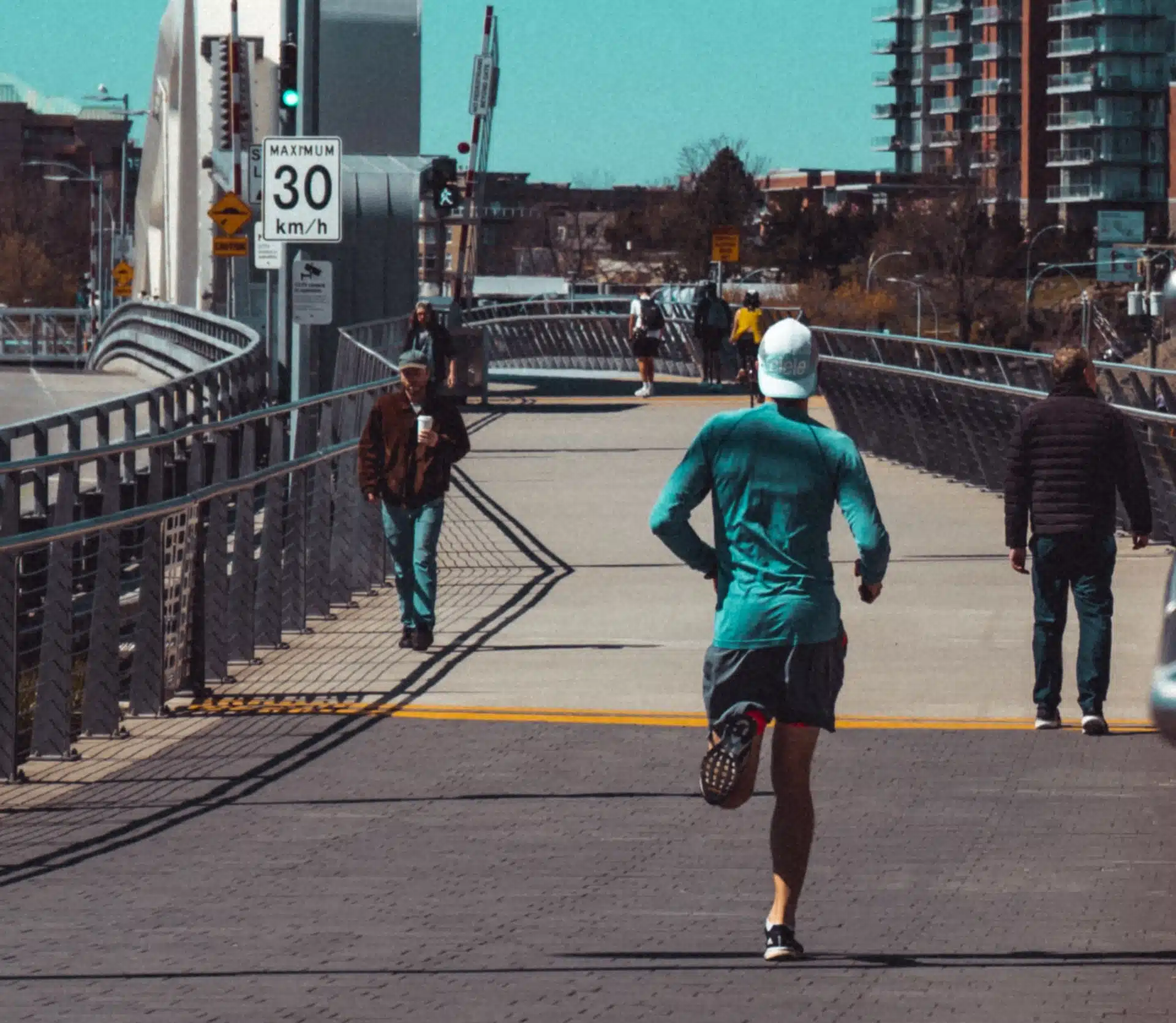 Runner running across a bridge