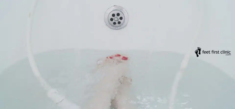 Toenails and feet soaking in a bath tub