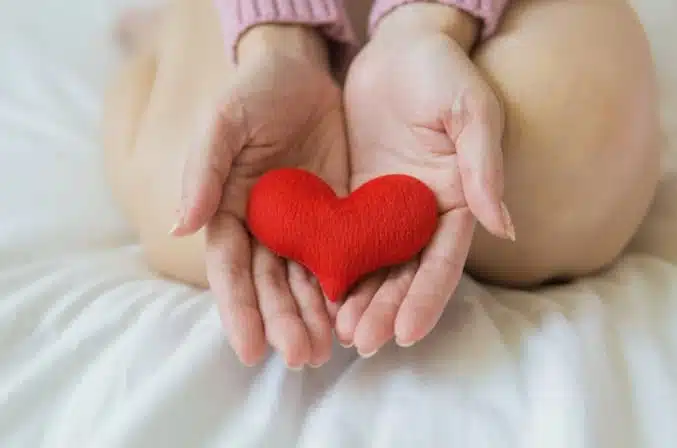 Woman holding stuffed heart
