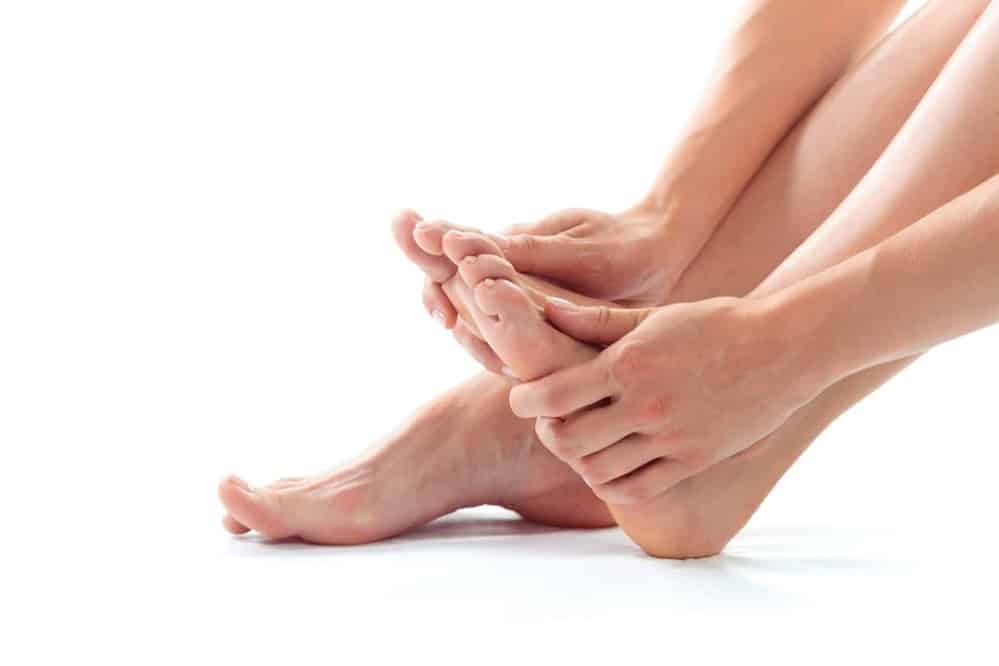 Itchy top of the feet close up white background