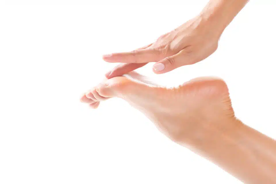 Close up of woman touching ball of the foot
