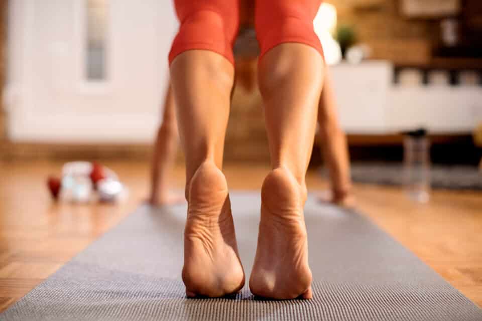 Woman exercising and stretching using a mat