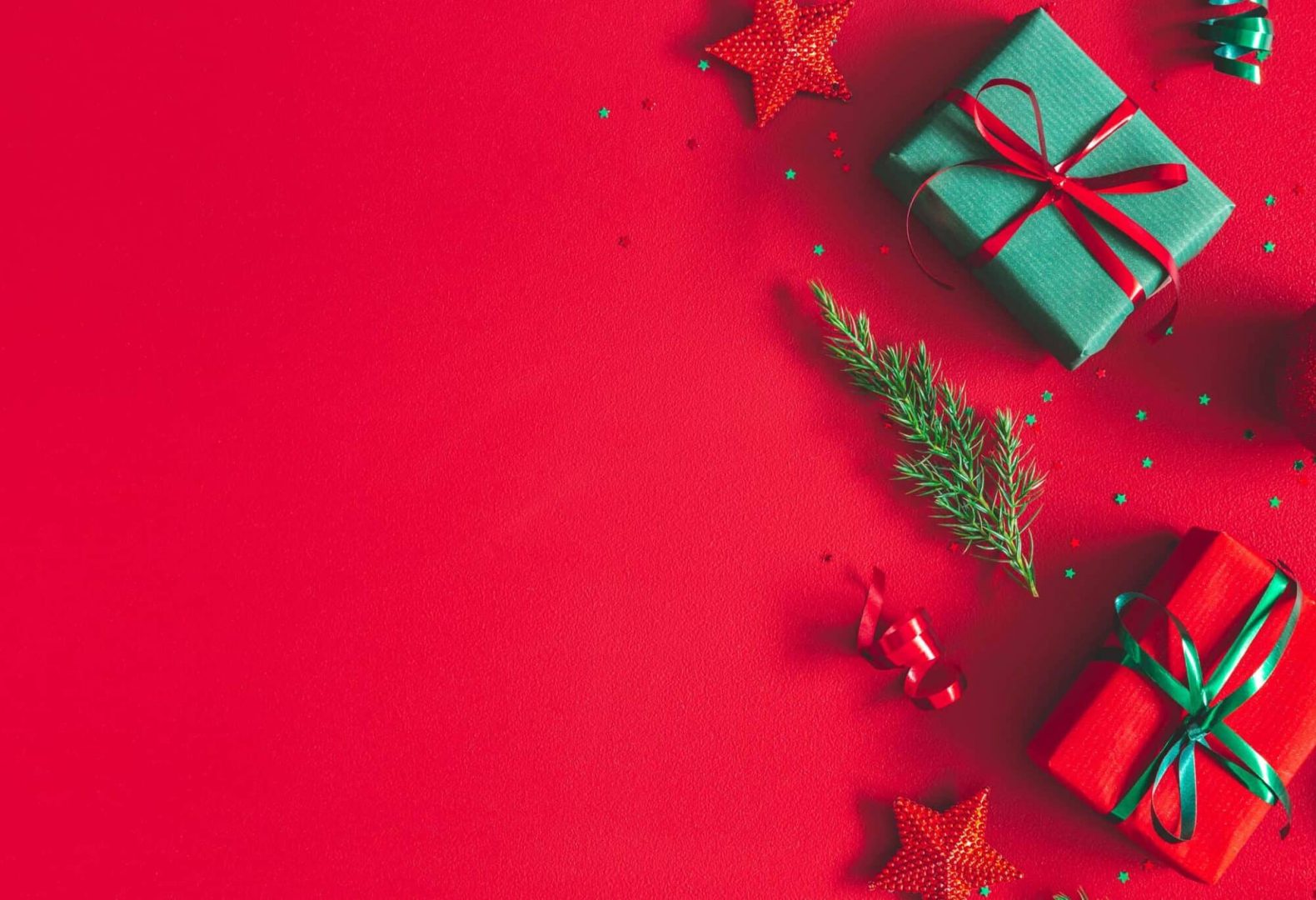 Christmas composition. Gift box, christmas decorations on red background. Flat lay, top view, copy space