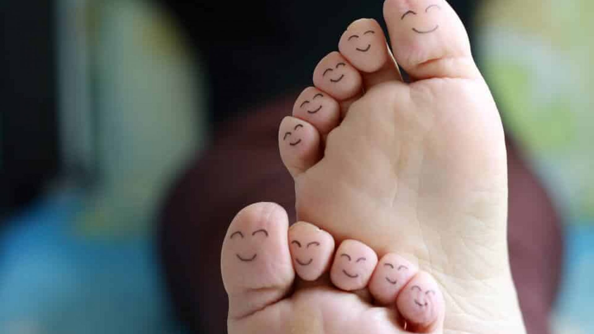 close up of ten toes with smiley faces on them