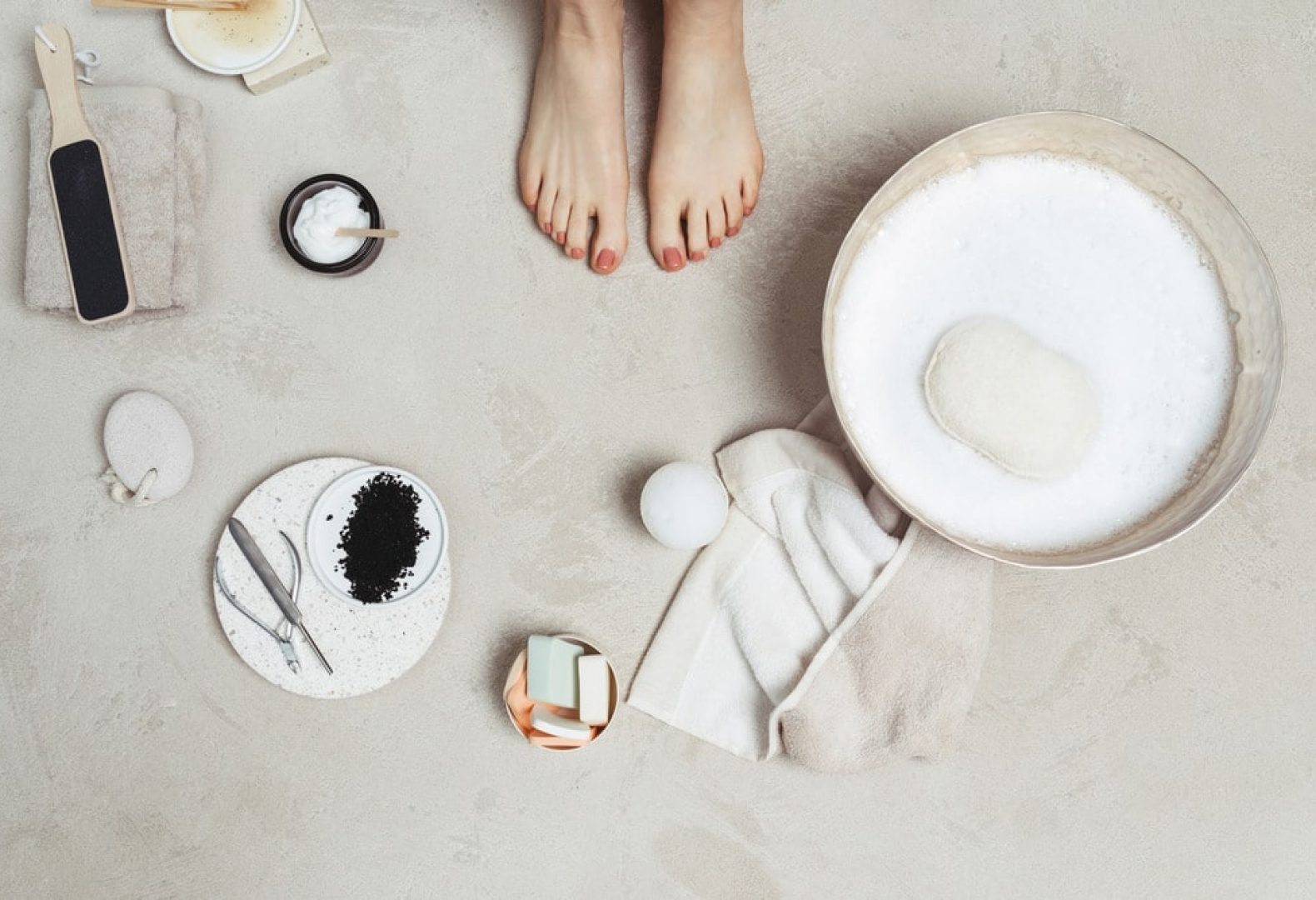 Close up of pedicure and supplies surrounding feet