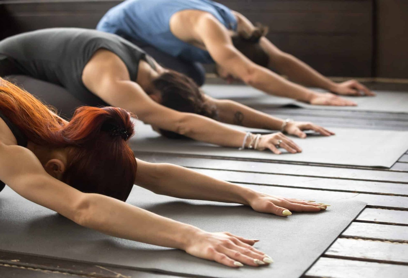 Group of people performing yoga poses together