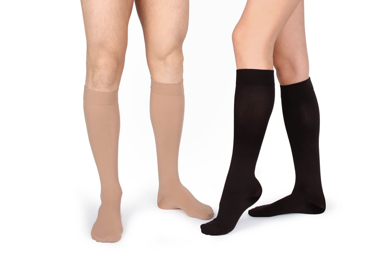 two people lower half wearing compression stockings with tight calves one pair is nude the other pair is black