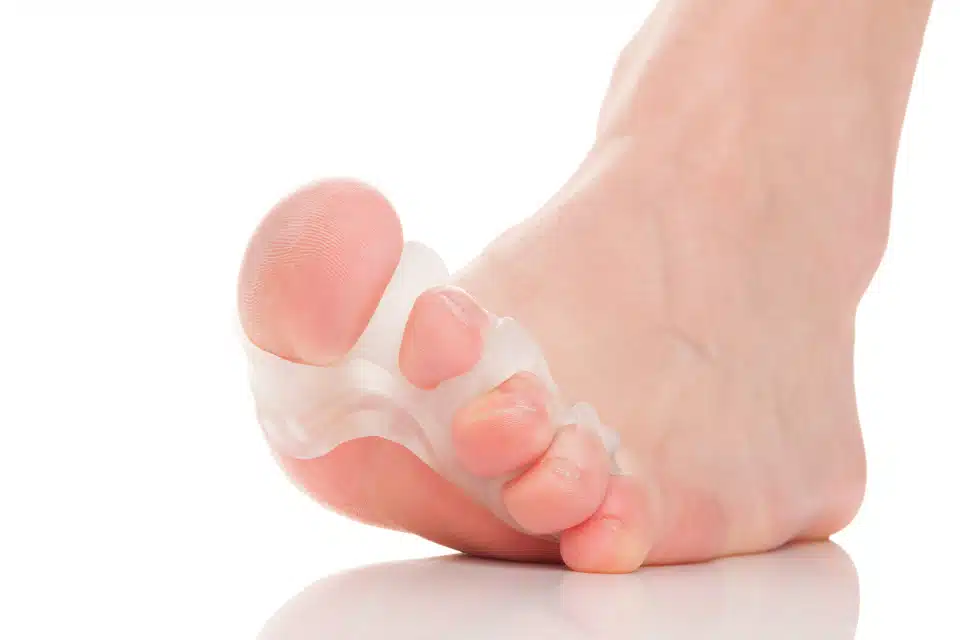 close up of toe separator device and toes white background