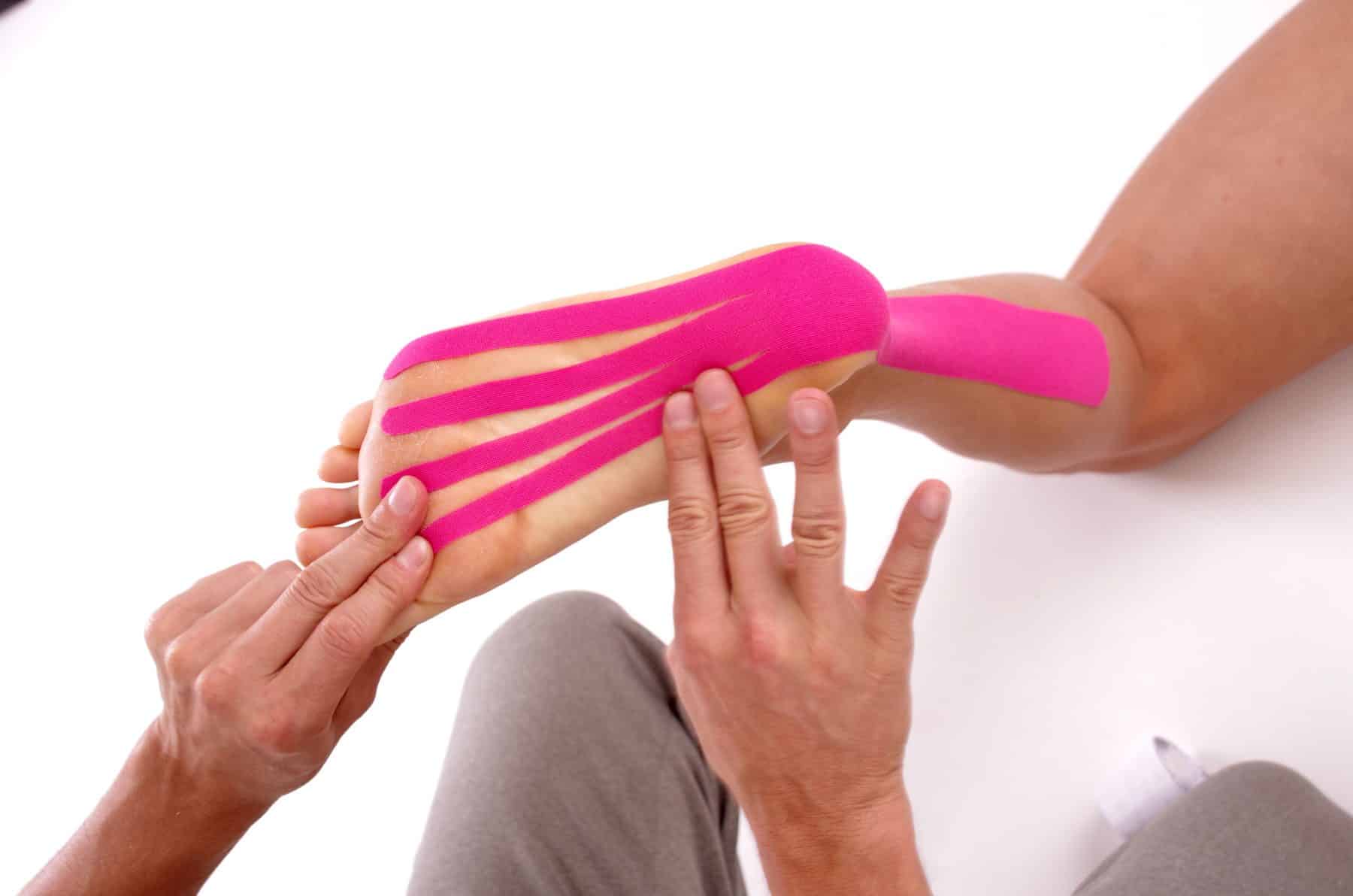 Kinesiology tape on achilles tendon and foot. Physiotherapy for athlete