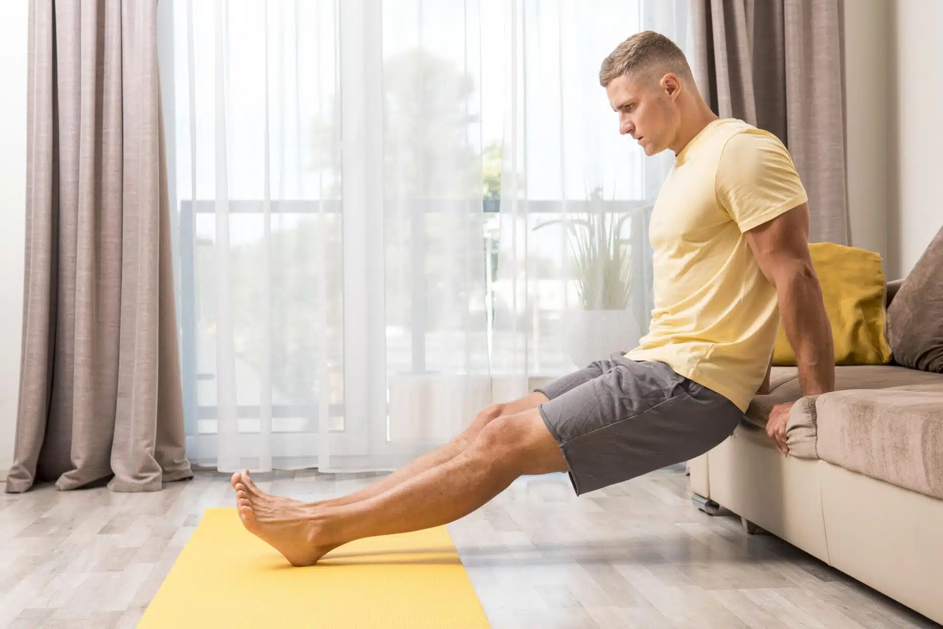 Man doing at-home stretches may counteract summer and foot swelling