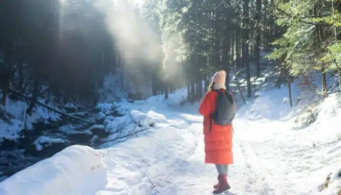 Girl walking on winter path wearing boots