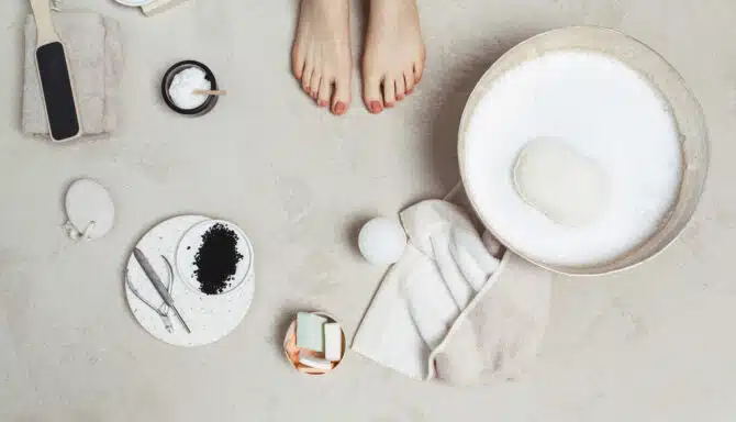 Close up of pedicure and supplies surrounding feet