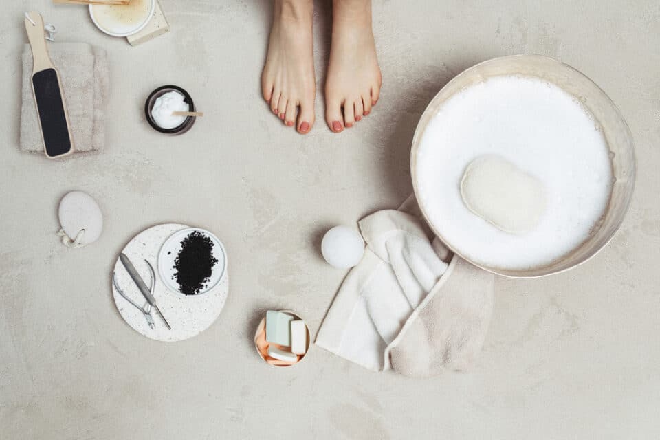 Close up of pedicure and supplies surrounding feet