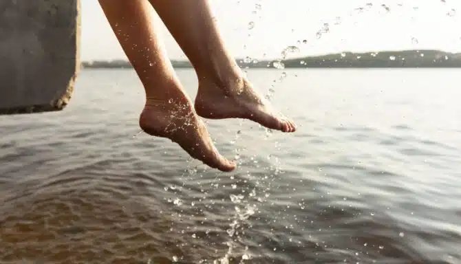 Woman splashing her feet in the water during summer