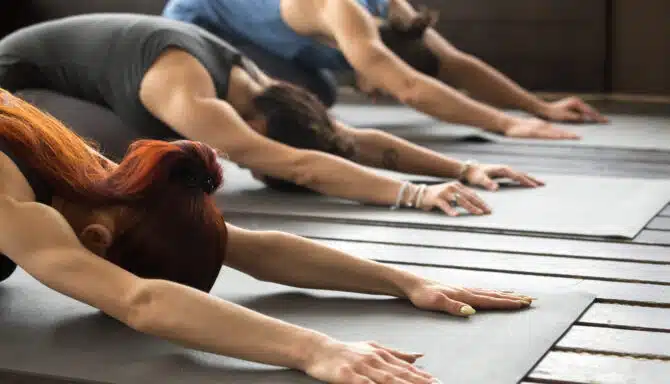 Group of people performing yoga poses together